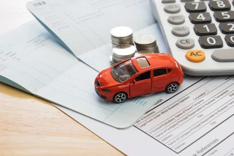 model-car-surrounded-by-cash-and-documents